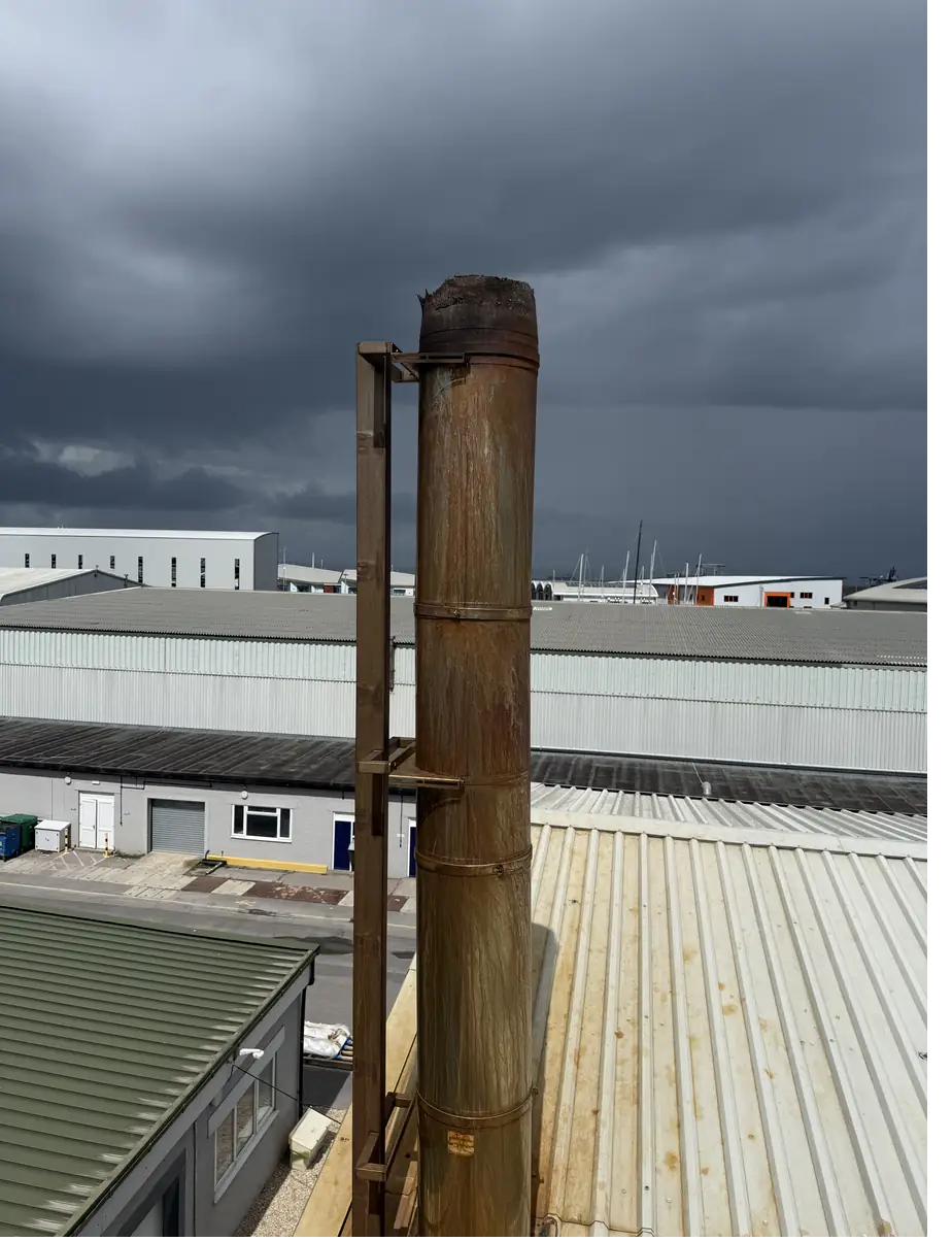 Commercial biomass flue stack on an industrial roof